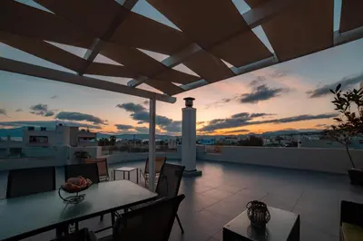 a balcony with a table and chairs and a lighthouse at Home Sweet Home - Big Balcony with Great View in Kissamos