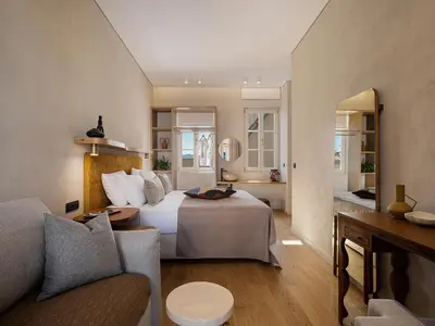 a hotel room with a bed and a couch at Casa Modiano Boutique in Chania Town