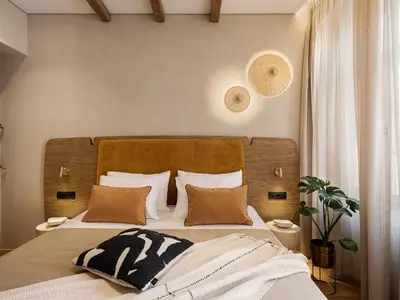 a bedroom with a large bed with two pillows at Casa Modiano Boutique in Chania Town