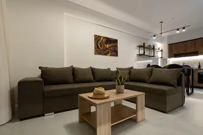 a living room with a couch and a table at Ruby Luxury Suites in Chania Town