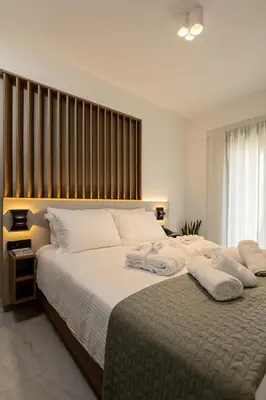 a bedroom with two beds with white pillows at Ruby Luxury Suites in Chania Town
