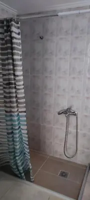 a shower in a bathroom with a shower head at Chania Luxury Apartments in Chania Town