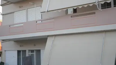 a close up of a building with white and pink at Chania Luxury Apartments in Chania Town