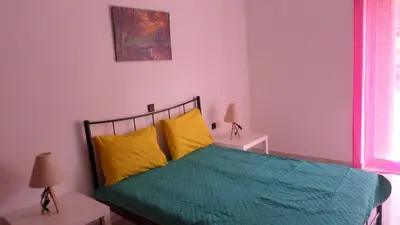 a bedroom with a bed with yellow and green sheets at Chania Luxury Apartments in Chania Town