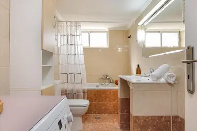 a bathroom with a sink and a toilet and a tub at Vasiliki house in Daratso