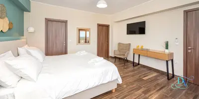 a bedroom with a bed and a desk and a television at Apokoronas Views Villa in Néon Khoríon