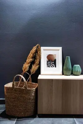 a picture frame and a basket on a table with vases at Nostos Central Apartment in Chania Town