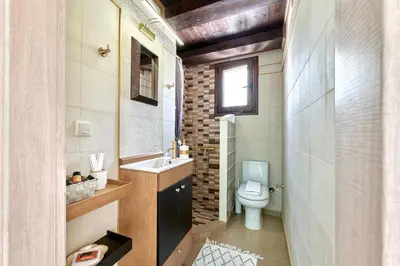 a small bathroom with a toilet and a sink at Sunaktis luxury villa in Chania Town