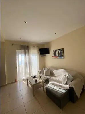 a living room with a bed and a couch at Koundouros Home in AmigdhalokeFálion