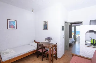 a small room with a bed and a table at Delfini Apartments in Kissamos