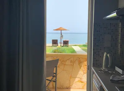 a kitchen with a view of the ocean and an umbrella at Ermis Suites in Plataniás