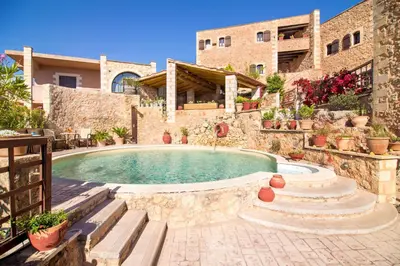 a house with a swimming pool in a yard at Samonas Traditional Villas in Samonás