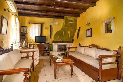a living room with two couches and a fireplace at Samonas Traditional Villas in Samonás