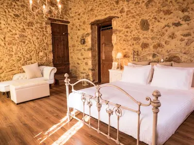 a bedroom with a white bed and a couch at Villa Malaxa Private Luxury with Amazing View in Maláxa