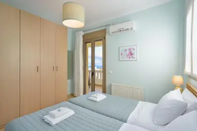 a bedroom with two beds with towels on them at PanDora maisonette with beautiful gardens and pool in Maleme