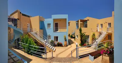 a row of houses with stairs in a courtyard at Futura Hotel in Maleme