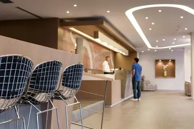 a row of chairs in a lobby with a counter at Kriti Hotel in Chania Town