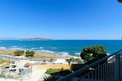 a view of the ocean from a balcony at Renieris Hotel in Stalos