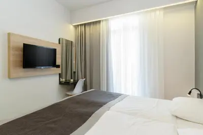a hotel room with a bed and a tv at Renieris Hotel in Stalos