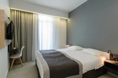 a bedroom with a large bed and a window at Renieris Hotel in Stalos