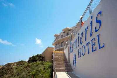 a building with a sign on the side of it at Renieris Hotel in Stalos