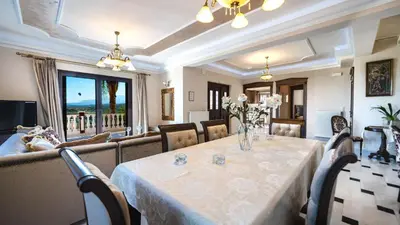 a dining room with a table and a couch at Iro Royal Villa by PosarelliVillas in Dhémbla