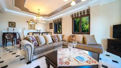 a living room with a couch and a table at Iro Royal Villa by PosarelliVillas in Dhémbla