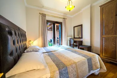a bedroom with a bed with a checkered blanket at Iro Royal Villa by PosarelliVillas in Dhémbla