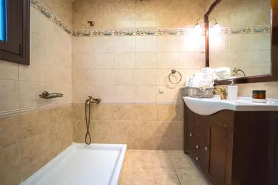 a bathroom with a tub and a sink at Iro Royal Villa by PosarelliVillas in Dhémbla