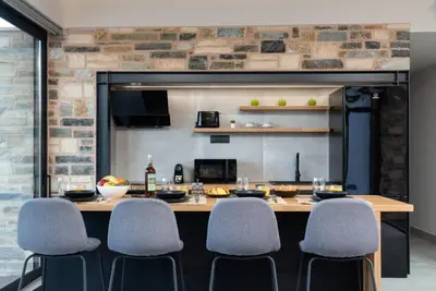 a dining room with a table and chairs at Villa Kallos by PosarelliVillas in Païdhokhórion
