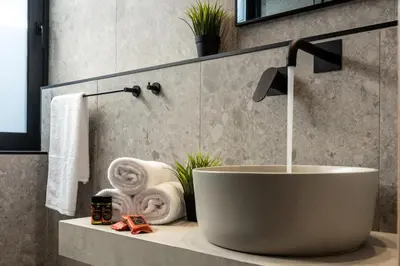a bathroom with a bath tub and a sink at Villa Kallos by PosarelliVillas in Païdhokhórion