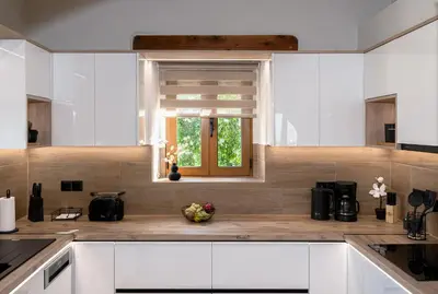 a kitchen with white cabinets and a window at Stone villa Halepa panoramic view, private pool,big garden & quiet in Néon Khoríon