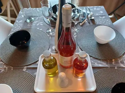 a table with a bottle of wine on a tray at Mini Villa Kalathas in Kalathas