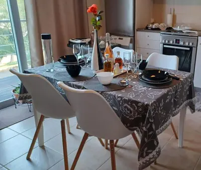 a dining room table with a black and white table cloth at Mini Villa Kalathas in Kalathas