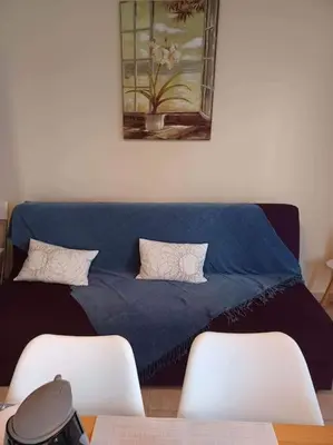 a blue couch in a room with two chairs at Mini Villa Kalathas in Kalathas