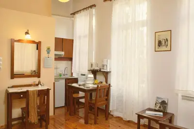 a kitchen with a table and a kitchen with a sink and a kitchen at Silde Studios & Apartments in Chania Town