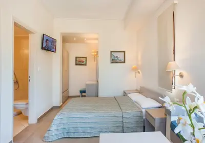 a hotel room with a bed and a bathroom at Frideriki Studios & Apartments in Plataniás