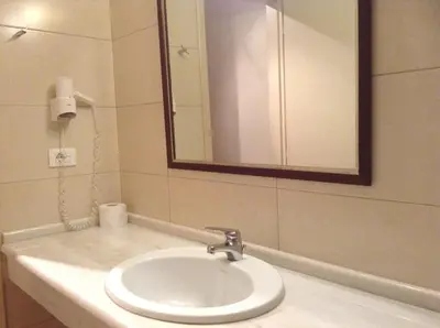 a bathroom with a sink with a mirror and a mirror at Frideriki Studios & Apartments in Plataniás