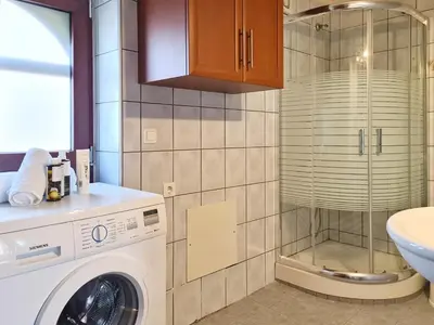 a bathroom with a washing machine and a sink at Enastron vacation house in Kissamos