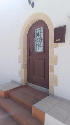 a brown door on the side of a building at Enastron vacation house in Kissamos
