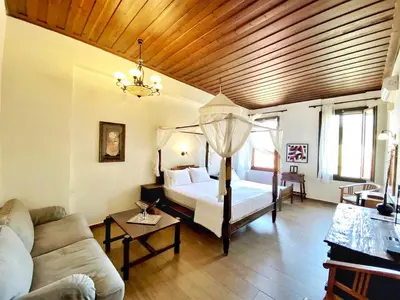 a living room with a bed and a couch at Boutique Hotel Del Doge in Chania Town
