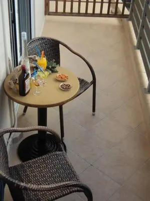 a table with two chairs and a table with drinks at The Getaway in Agia Marina Nea Kydonias