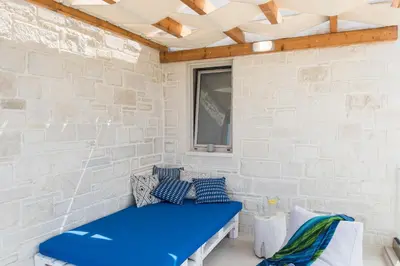 a blue bench in a room with a brick wall at Falasarna Luxury Villas I Private 