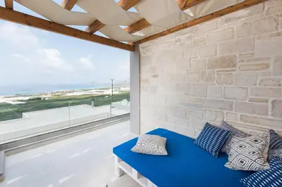 a room with a blue couch and a large window at Falasarna Luxury Villas I Private 