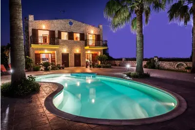 a large swimming pool in front of a house at Erodios Villas 2 in Ptinotrofíon
