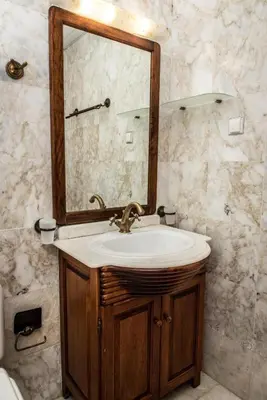 a bathroom with a sink and a mirror at Erodios Villas 2 in Ptinotrofíon