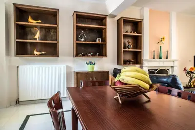 a room with a wooden table with bananas on a chair at Erodios Villas 2 in Ptinotrofíon