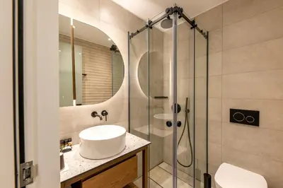 a bathroom with a sink and a shower at El Greco Hotel in Chania Town