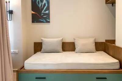 a bed with two pillows in a room at El Greco Hotel in Chania Town
