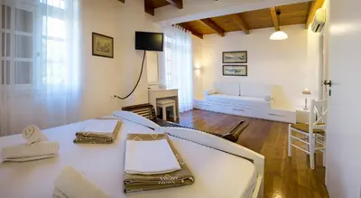 a living room with a white table and a couch at Ontas Traditional Hotel in Chania Town